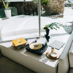 a table with a record player and a plant on it